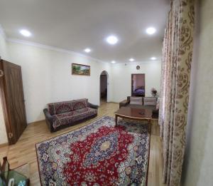 a living room with a couch and a rug at Апартаменты in Tashkent