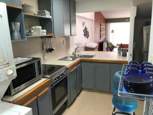a kitchen with a sink and a stove top oven at Casa en Caribbean con Wifi in Tucacas