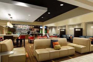 a lobby with couches and tables and a bar at Courtyard by Marriott Dallas-Fort Worth/Bedford in Bedford