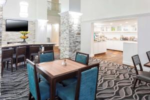 a dining room and kitchen with a table and chairs at Homewood Suites by Hilton Chattanooga - Hamilton Place in Chattanooga