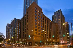 a large building on a city street at night at Embassy Suites Chicago - Downtown River North in Chicago