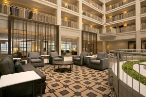 a lobby of a hotel with chairs and tables at Embassy Suites Chicago - Downtown River North in Chicago
