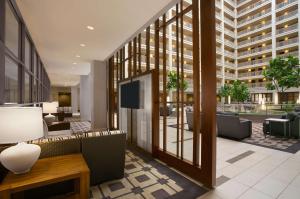a lobby of a building with chairs and a table at Embassy Suites Chicago - Downtown River North in Chicago
