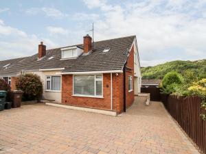 a brick house with a brick driveway at 4 Bodnant Road in Colwyn Bay