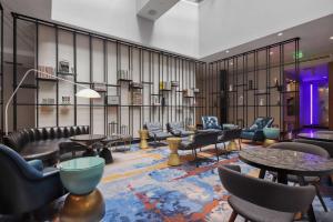 a waiting room with couches and tables and chairs at Canopy By Hilton Memphis Downtown in Memphis