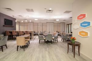 a conference room with tables and chairs and a tv at Hampton Inn & Suites Denver-Downtown in Denver