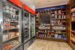 a grocery store aisle with a refrigerator and shelves of food at Hampton Inn & Suites Denver-Downtown in Denver +48 photos