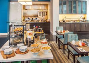 a kitchen with a table with bowls of food at Hilton Garden Inn NYC Financial Center/Manhattan Downtown in New York