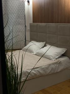 a bed with white sheets and pillows in a room at Loft inn in Makhunts'et'i
