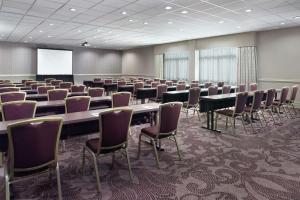 a conference room with tables and chairs and a screen at Hilton Garden Inn Atlanta-Buckhead in Atlanta