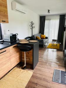 a kitchen and living room with a counter and a counter top at Tiny House by the forest “2” 