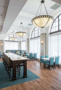 a dining room with tables and chairs and windows at Hampton Inn & Suites Atlanta-Downtown in Atlanta