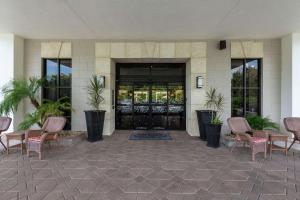 a lobby of a building with chairs and a door at Hampton Inn Boca Raton in Boca Raton