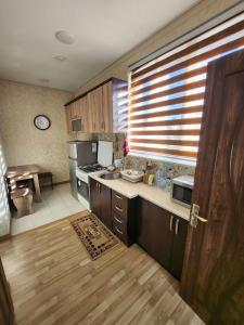 a kitchen with wooden cabinets and a counter top at Апартаменты in Tashkent