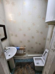 a small bathroom with a sink and a toilet at Апартаменты in Tashkent