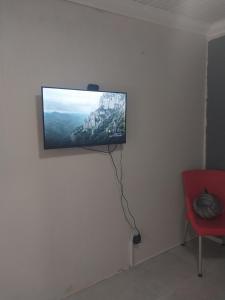 a flat screen tv hanging on a wall in a room at Comfort place 3 in Pretoria