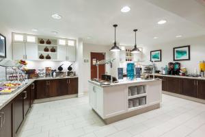 a large kitchen with wooden cabinets and a counter top at Homewood Suites by Hilton Birmingham South Inverness in Hoover