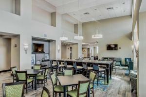 ein Restaurant mit Tischen und Stühlen und eine Bar in der Unterkunft Hampton Inn and Suites Clearwater Beach in Clearwater Beach