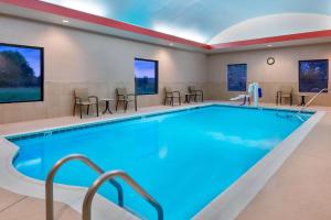 a pool in a hotel room with a large swimming pool at Hampton Inn & Suites Winston-Salem/University Area in Winston-Salem