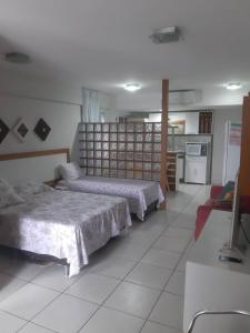 une chambre avec deux lits et une cuisine dans l'établissement Terrazzo PontaNegra flat Flat Vista Mar Apto 201, à Natal