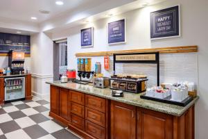 a coffee shop with a counter in a restaurant at Hampton Inn & Suites Mobile I-65@ Airport Boulevard in Mobile