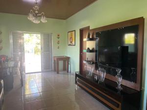 a living room with a large flat screen tv at Residencial das Cachoeiras in Presidente Figueiredo