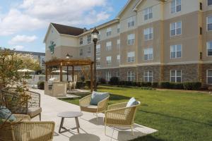 a hotel with chairs and a gazebo in a yard at Homewood Suites by Hilton Knoxville West at Turkey Creek in Knoxville