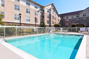 a large swimming pool in front of a building at Homewood Suites by Hilton Knoxville West at Turkey Creek in Knoxville