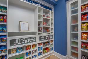 a walk in pantry with white shelves and blue walls at Hampton Inn & Suites Knoxville-Turkey Creek Farragut in Knoxville