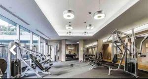 a gym with treadmills and machines in a room at Beautiful Unit in Heart of Downtown Toronto in Toronto