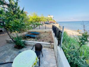 a table and chairs sitting next to the beach at Marielpi Beach House in Skala Kallirachis