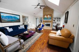 a living room with blue furniture and a fireplace at Gorgeous Plano Home ~ Private Backyard Pool Oasis in Plano