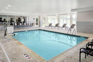 a large pool with blue water in a building at Hilton Garden Inn Cincinnati Northeast in Loveland