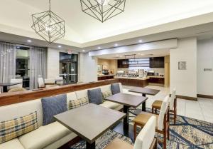 a restaurant with tables and chairs and a kitchen at Homewood Suites by Hilton Dallas/Allen in Allen