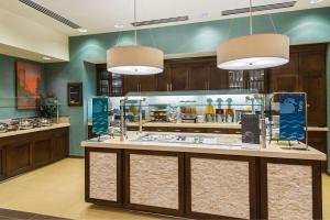 a food counter in a restaurant with two pendant lights at Homewood Suites by Hilton Little Rock Downtown in Little Rock