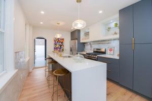 a kitchen with blue cabinets and a white counter top at Spacious 3 BDR Home With Parking Hosted By StayRafa 1121 in Philadelphia