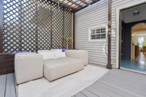 a patio with two white couches on a porch at Spacious 3 BDR Home With Parking Hosted By StayRafa 1121 in Philadelphia