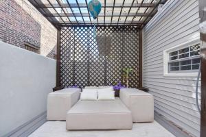 a patio with white couches and a window at Spacious 3 BDR Home With Parking Hosted By StayRafa 1121 in Philadelphia