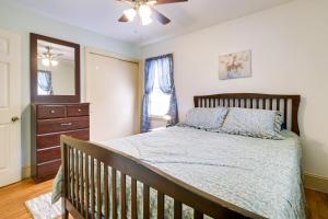 a bedroom with a bed and a dresser and a mirror at Fayetteville Vacation Rental about 6 Mi to Downtown! in Fayetteville
