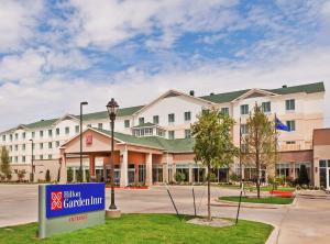 a hotel with a sign in front of a building at Hilton Garden Inn Midland in Midland