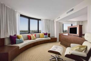 a living room with a couch and a tv at Hilton Miami Airport Blue Lagoon in Miami