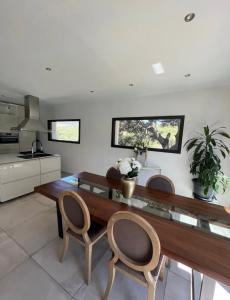a kitchen with a wooden table and two chairs at Villa dans les hauteurs de Marseille in Marseille