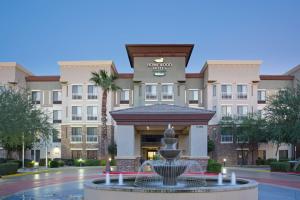 a hotel with a fountain in front of a building at Homewood Suites by Hilton Phoenix-Avondale in Avondale