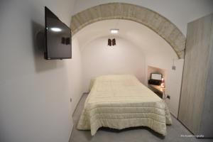 a bedroom with a bed and a tv in it at Home Ginny in Terlizzi
