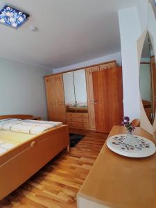 a bedroom with two beds and a table with a plate on it at A&A Urlaubswohnung Piesport in Piesport