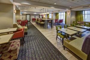 a dining room with tables and chairs in a restaurant at Hampton Inn Dunn in Dunn