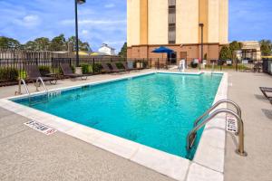 a swimming pool with blue water in a building at Hampton Inn Dunn in Dunn