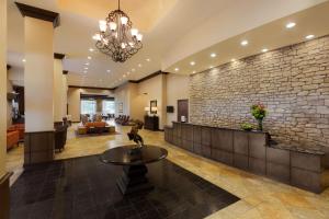 a lobby of a hotel with a stone wall at Hilton Phoenix Chandler in Chandler