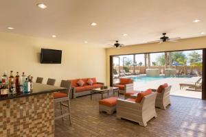 a living room with a pool in the background at Hilton Phoenix Chandler in Chandler