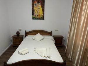 a bed with white sheets and two napkins on it at Cazare David si familia . in Piatra Neamţ
